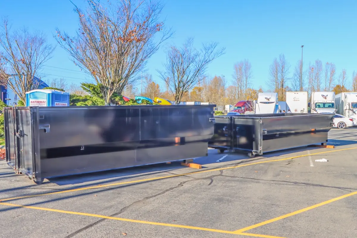 Professional dumpster rental service with roll-off container on residential driveway in Fox Lake